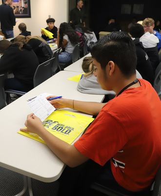  Boy looking at paper at the University of Nebraska at Kearney